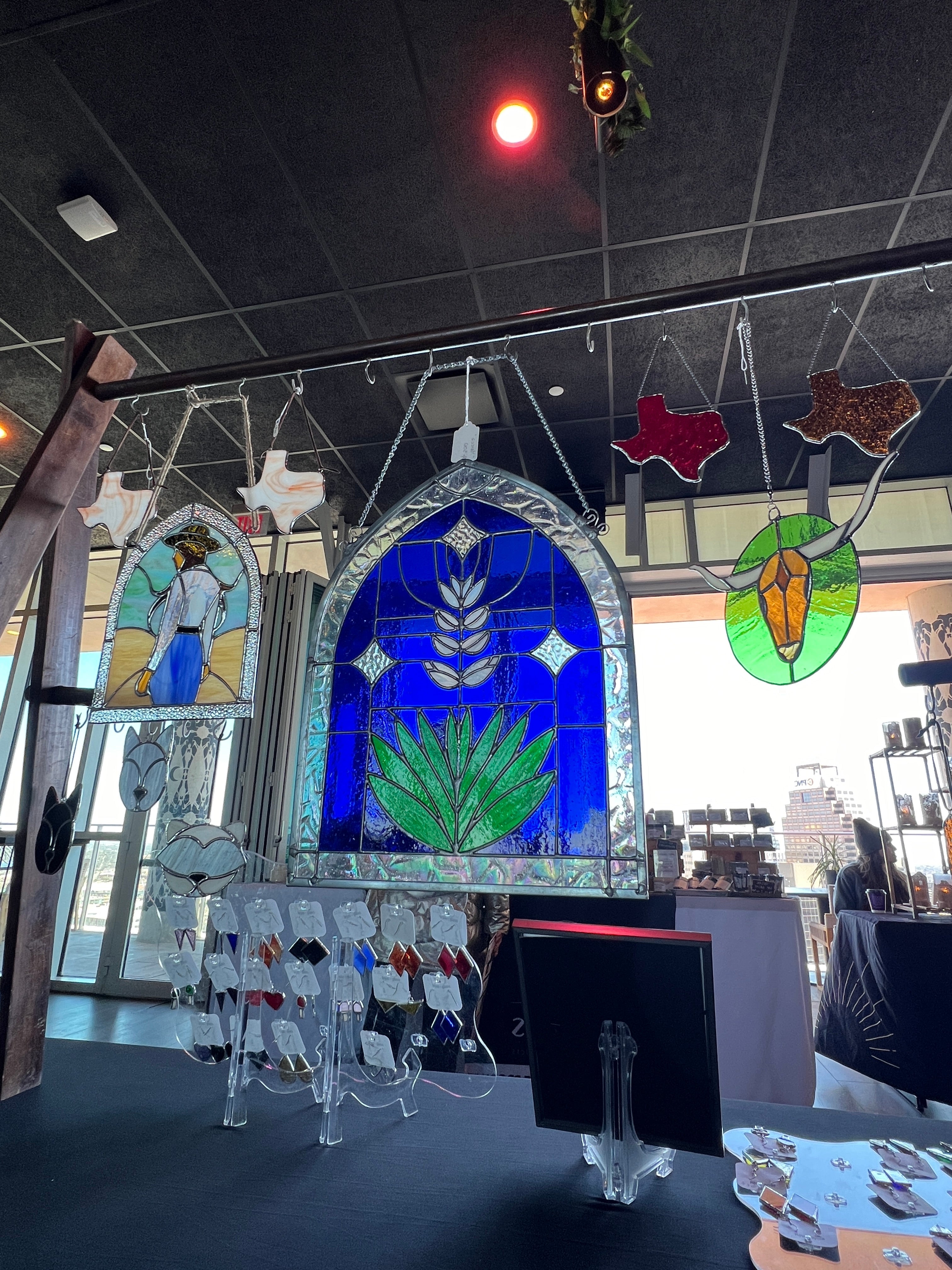 Stained glass windows with various designs on a dark tiled floor.